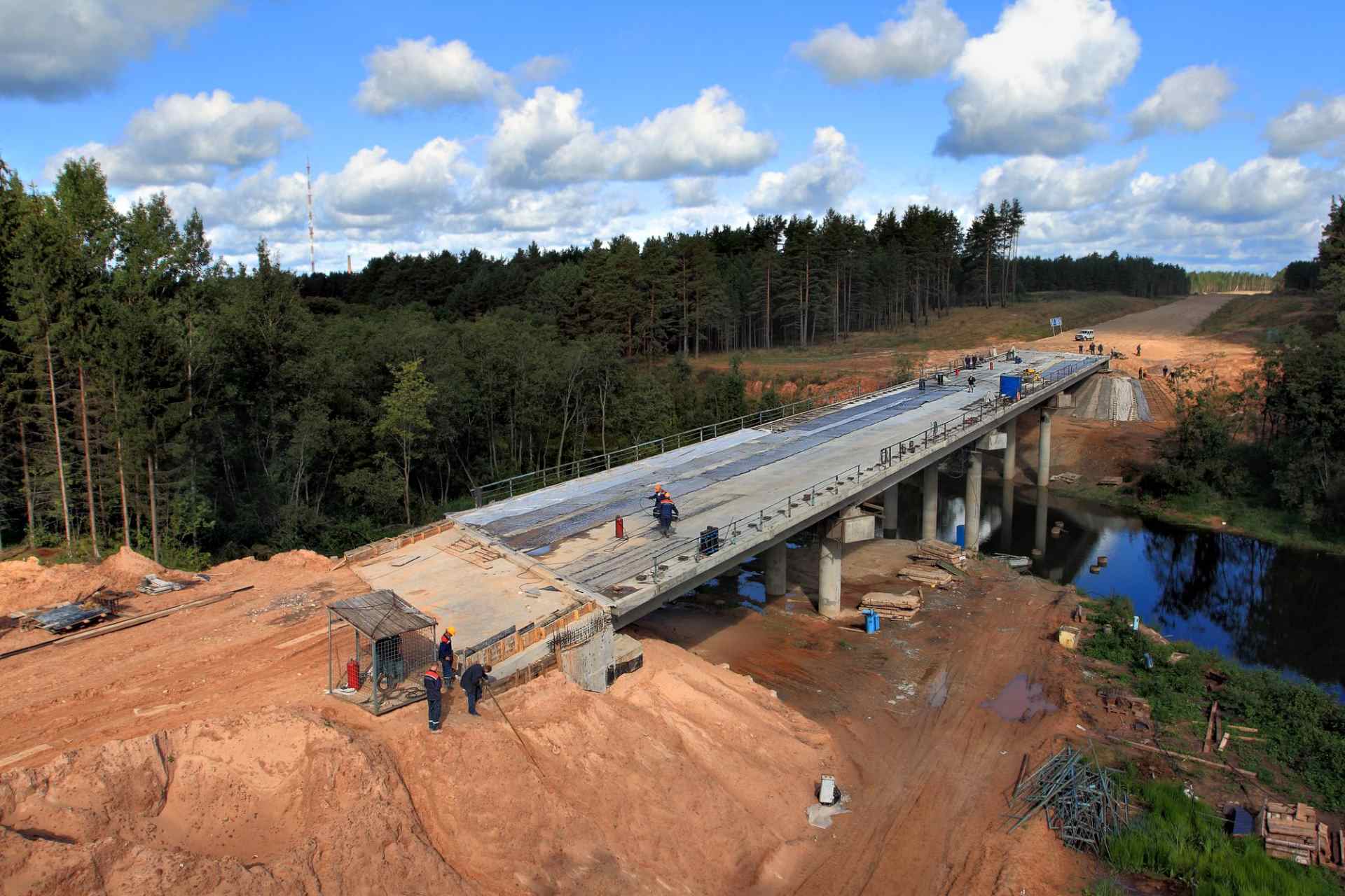 M2X Construction engineers working on bridge structure restoration